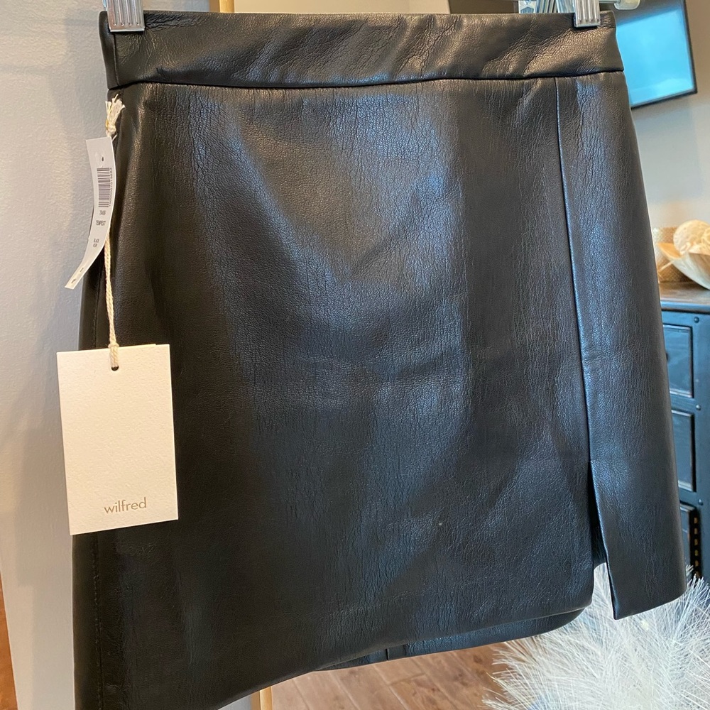 Aritzia black, vegan leather skirt with slit.